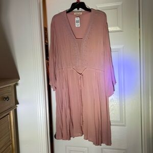 Pink long sleeve knee length dress.